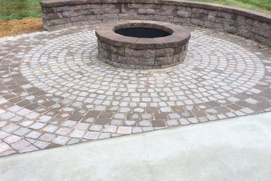 Mid-sized transitional backyard concrete paver patio photo in Other with a fire pit and no cover