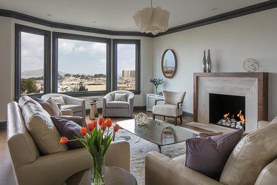 Living room - transitional dark wood floor living room idea in San Francisco with beige walls, a standard fireplace, no tv and a stone fireplace
