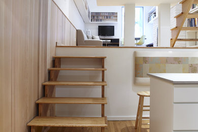Staircase - scandinavian wooden open staircase idea in New York