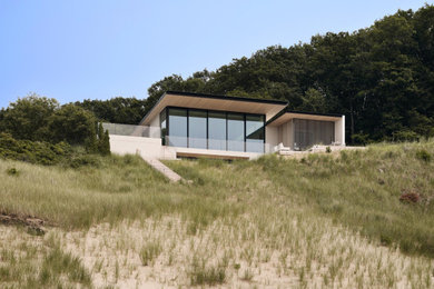 Mid-sized trendy beige two-story stucco house exterior photo in Chicago with a shed roof