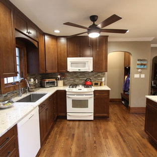 Mid-sized transitional kitchen pantry designs - Mid-sized transitional l-shaped medium tone wood floor and brown floor kitchen pantry photo in Cleveland with an undermount sink, shaker cabinets, medium tone wood cabinets, quartz countertops, brown backsplash, glass tile backsplash, white appliances and an island