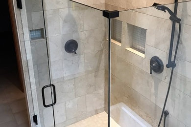 Mid-sized transitional beige tile and stone tile limestone floor and beige floor alcove shower photo in Portland with beige walls and a hinged shower door