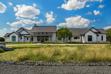 Example of a farmhouse exterior home design in Austin