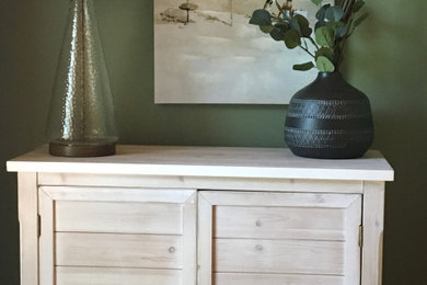 Small beach style guest laminate floor and orange floor bedroom photo in Other with green walls