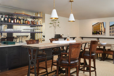 Home bar - transitional carpeted and beige floor home bar idea in Grand Rapids with an undermount sink, flat-panel cabinets, black cabinets, quartzite countertops and white countertops