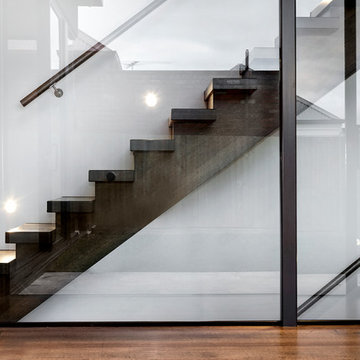 Timber Staircase from ground floor encased in glass