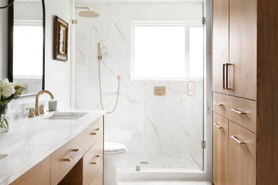 Example of a mid-sized transitional master white tile and porcelain tile ceramic tile, gray floor and double-sink bathroom design in Dallas with flat-panel cabinets, light wood cabinets, a two-piece toilet, white walls, an undermount sink, quartz countertops, a hinged shower door, white countertops and a floating vanity