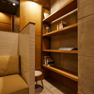 Inspiration for a medium sized modern home office and library in Other with a reading nook, brown walls, porcelain flooring, a built-in desk and grey floors.