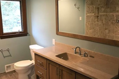 Bathroom - large traditional master bathroom idea in Orange County with recessed-panel cabinets, medium tone wood cabinets, a two-piece toilet, blue walls and an integrated sink