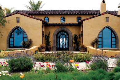 Large mediterranean two-story stucco exterior home idea in San Diego with a tile roof
