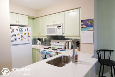 Inspiration for a l-shaped eat-in kitchen remodel in Toronto with an undermount sink, shaker cabinets, green cabinets, quartz countertops, multicolored backsplash, ceramic backsplash, white appliances and white countertops