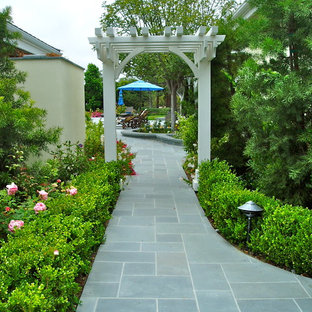 Photo of a traditional courtyard full sun garden in San Diego with natural stone pavers.