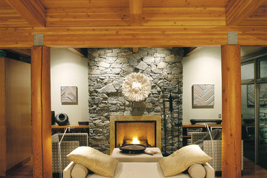 Large elegant open concept light wood floor living room photo in Calgary with beige walls and a stone fireplace