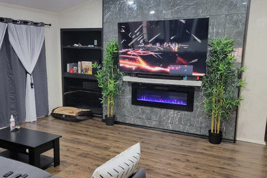 Family room photo in Dallas with a tile fireplace and a wall-mounted tv