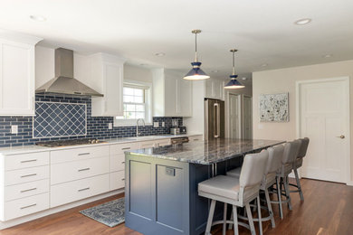 Large transitional single-wall medium tone wood floor and brown floor eat-in kitchen photo in Other with an undermount sink, shaker cabinets, white cabinets, granite countertops, blue backsplash, porcelain backsplash, stainless steel appliances, an island and blue countertops