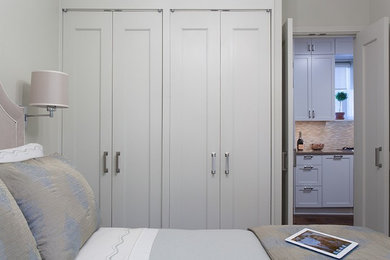 Example of a small transitional master carpeted bedroom design in New York with beige walls