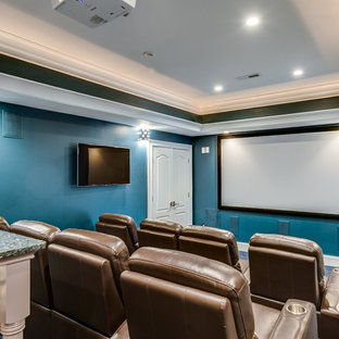 This is an example of a large traditional enclosed home cinema in Charlotte with blue walls, carpet, a projector screen and blue floors.