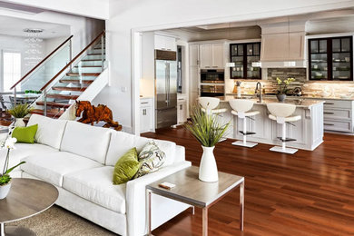 Example of a large classic open concept medium tone wood floor and brown floor living room design in Los Angeles