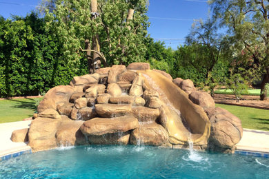 Pool fountain - mid-sized rustic backyard stamped concrete and custom-shaped natural pool fountain idea in Phoenix
