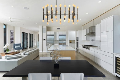Inspiration for a large contemporary l-shaped ceramic tile and gray floor open concept kitchen remodel in San Diego with an undermount sink, flat-panel cabinets, white cabinets, quartz countertops, white backsplash, glass tile backsplash, stainless steel appliances and an island
