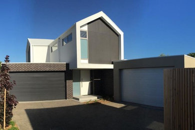 Mid-sized modern two-storey brick multi-coloured exterior in Melbourne with a gable roof.