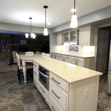 Beige Kitchen with Extra Large Island, Tile Backsplash and Granite Countertops