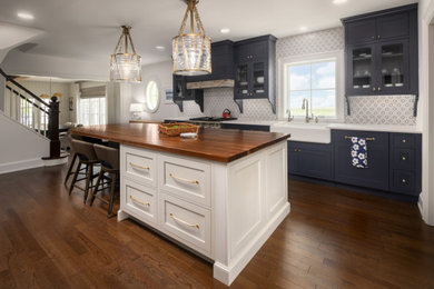 Example of a large transitional kitchen design in Chicago with recessed-panel cabinets, white cabinets, wood countertops, multicolored backsplash and white countertops