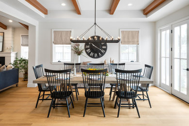 Example of a farmhouse light wood floor and shiplap wall dining room design in San Francisco with gray walls