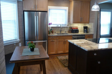 Example of a mid-sized transitional single-wall brown floor and light wood floor eat-in kitchen design in Milwaukee with an undermount sink, shaker cabinets, light wood cabinets, granite countertops, beige backsplash, ceramic backsplash, stainless steel appliances, an island and beige countertops