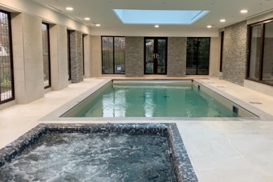 Photo of a large contemporary indoor rectangular hot tub in Other with tiled flooring.