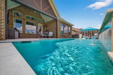 Inspiration for a contemporary backyard concrete and rectangular pool remodel in Houston