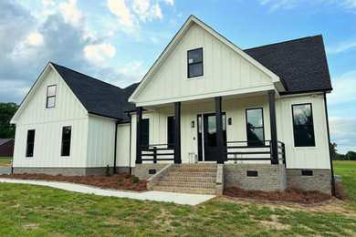 Cottage white concrete fiberboard and board and batten exterior home idea in Charlotte with a shingle roof and a black roof