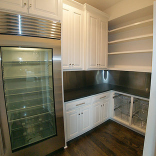 Mid-sized transitional kitchen pantry pictures - Kitchen pantry - mid-sized transitional l-shaped dark wood floor kitchen pantry idea in Kansas City with a farmhouse sink, recessed-panel cabinets, white cabinets, marble countertops, white backsplash, mosaic tile backsplash, stainless steel appliances and an island