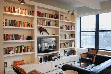 Inspiration for a mid-sized modern enclosed living room in New York with a library, white walls, dark hardwood floors and a built-in media wall.