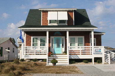 Inspiration for a mid-sized beach style two-storey brown exterior in Other with wood siding and a gable roof.