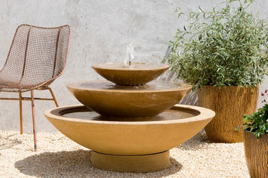 Design ideas for a mid-sized southwestern full sun courtyard gravel water fountain landscape in San Francisco for summer.