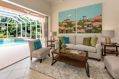 Large trendy open concept ceramic tile and beige floor living room photo in Tampa with beige walls