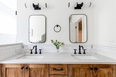 Alcove bathtub - mid-sized master white tile and porcelain tile porcelain tile and double-sink alcove bathtub idea in Atlanta with shaker cabinets, medium tone wood cabinets, white walls, an undermount sink, quartz countertops, a hinged shower door, white countertops, a niche and a built-in vanity