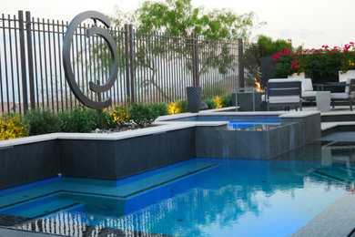 This is an example of a mid-sized contemporary backyard stone landscaping in Las Vegas.