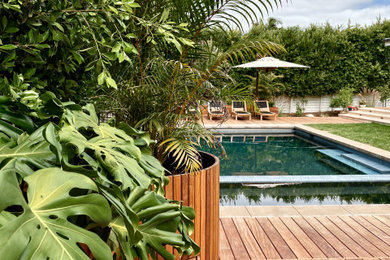 Pool - large coastal backyard rectangular pool idea in San Diego with decking