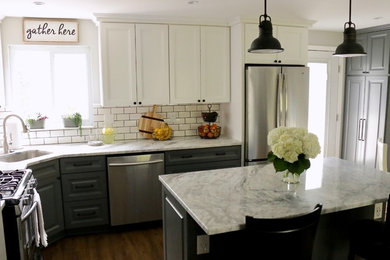 Inspiration for a small country l-shaped laminate floor and brown floor open concept kitchen remodel in Other with an undermount sink, raised-panel cabinets, gray cabinets, granite countertops, white backsplash, porcelain backsplash, stainless steel appliances, an island and white countertops