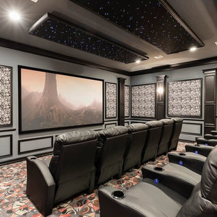 Example of a tuscan enclosed carpeted and multicolored floor home theater design in Orlando with multicolored walls and a projector screen