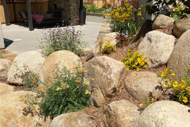 Patio - large mediterranean side yard stone patio idea in San Diego with a fireplace and a pergola