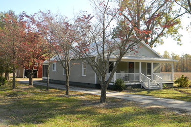 Inspiration for a small timeless gray one-story wood exterior home remodel in Raleigh with a metal roof