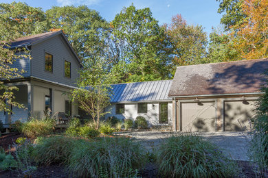 Inspiration for a country gray wood house exterior remodel in New York with a shingle roof