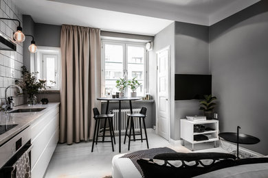 Design ideas for a small scandinavian open concept family room in Gothenburg with grey walls, painted wood floors, a wall-mounted tv and white floor.