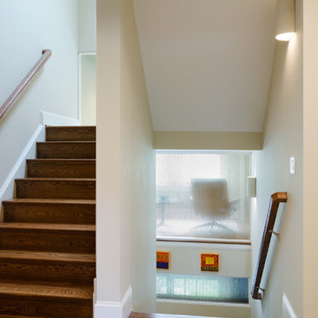 Three Story Stairwell With An Etched Glass Wall in Glen Allen