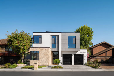 Mid-sized modern two-story mixed siding house exterior idea in Los Angeles with a mixed material roof and a gray roof