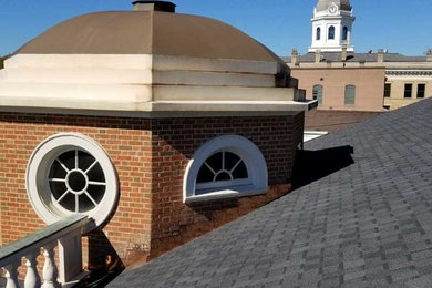 Mid-sized traditional brown one-story brick gable roof idea in Atlanta with a shingle roof