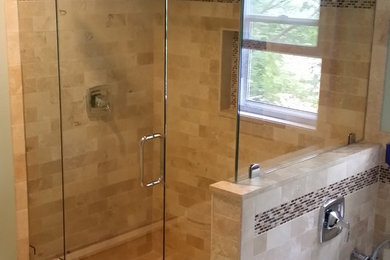 Photo of a mid-sized mediterranean master bathroom in Newark with a corner shower, beige tile and porcelain tile.